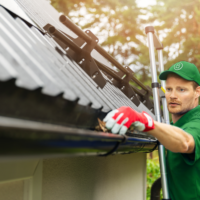 guy cleaning gutters