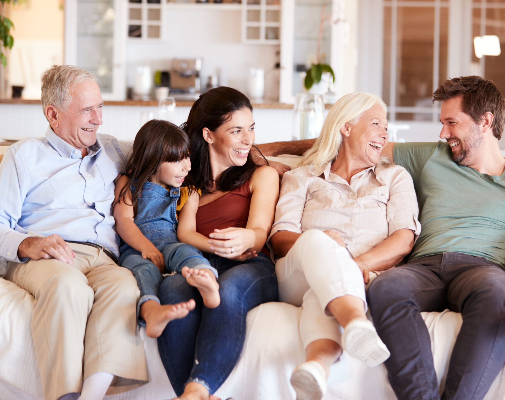 family sitting together laughing on couch